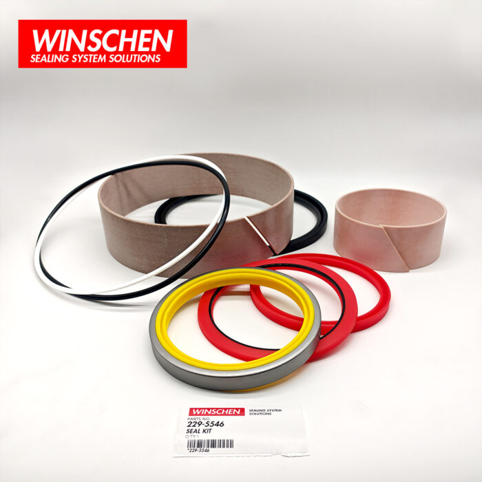 229-5546 tilt cylinder seal kit, low-angle view with red and yellow seals in front